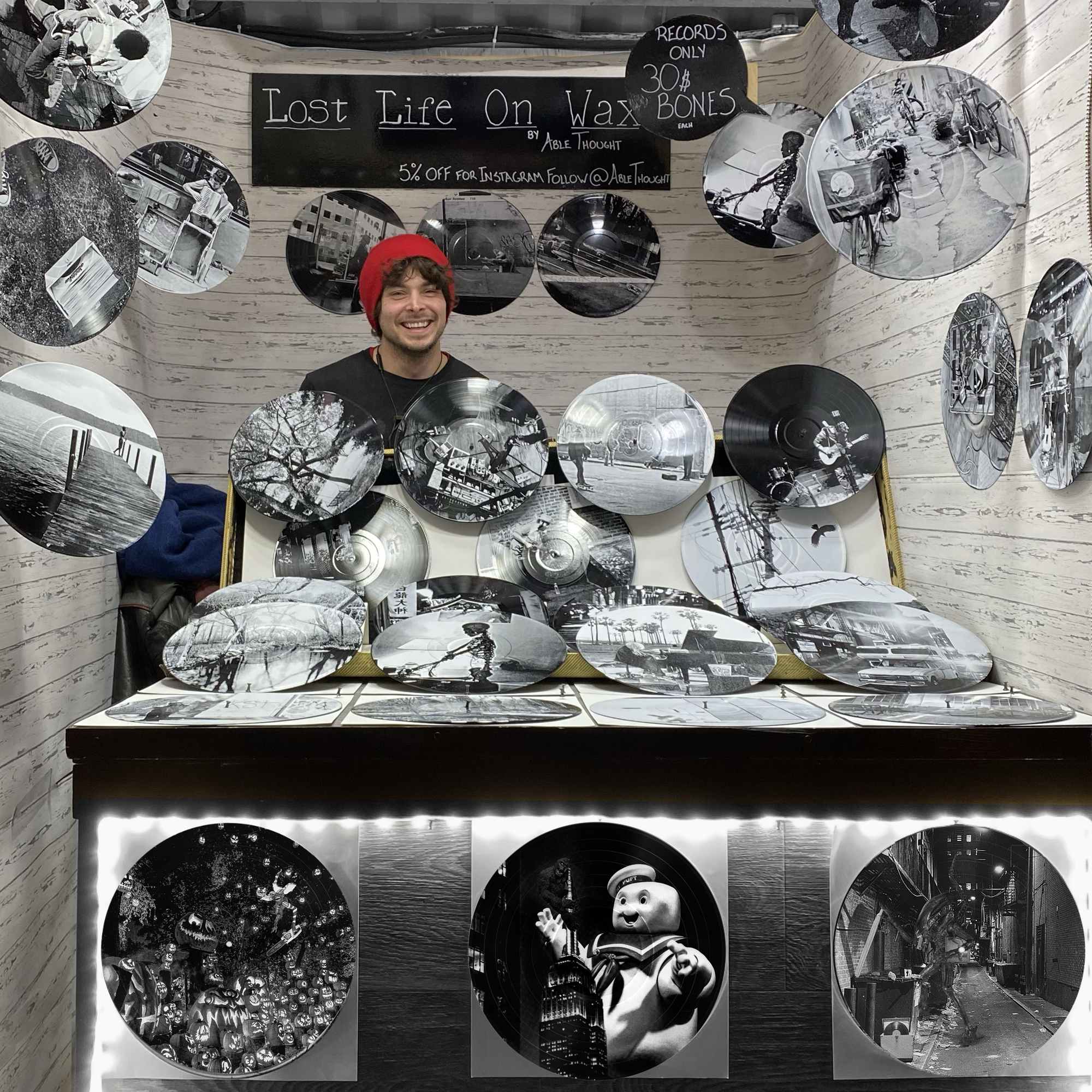 Vinyl record photo art of King Kong and Stay Puft on the Empire State Building, displayed at an art market booth.