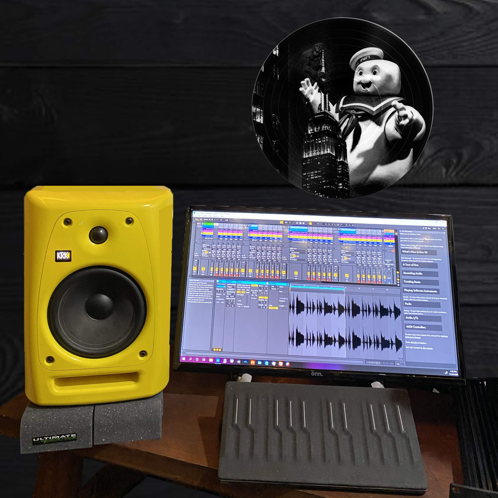 Black and white vinyl record wall art of King Kong and Stay Puft Marshmallow Man at the Empire State Building, displayed as office decor.