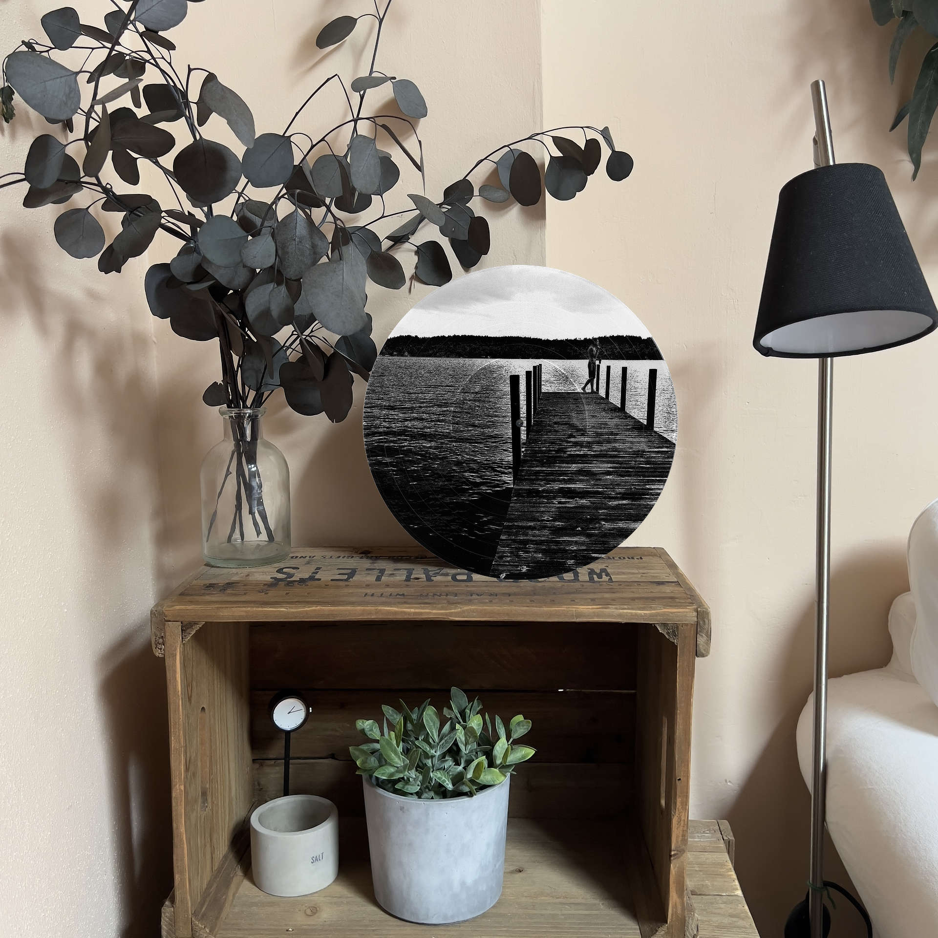 Upcycled vinyl record photo art of a person standing on a dock at sunrise, styled as living room wall decor.