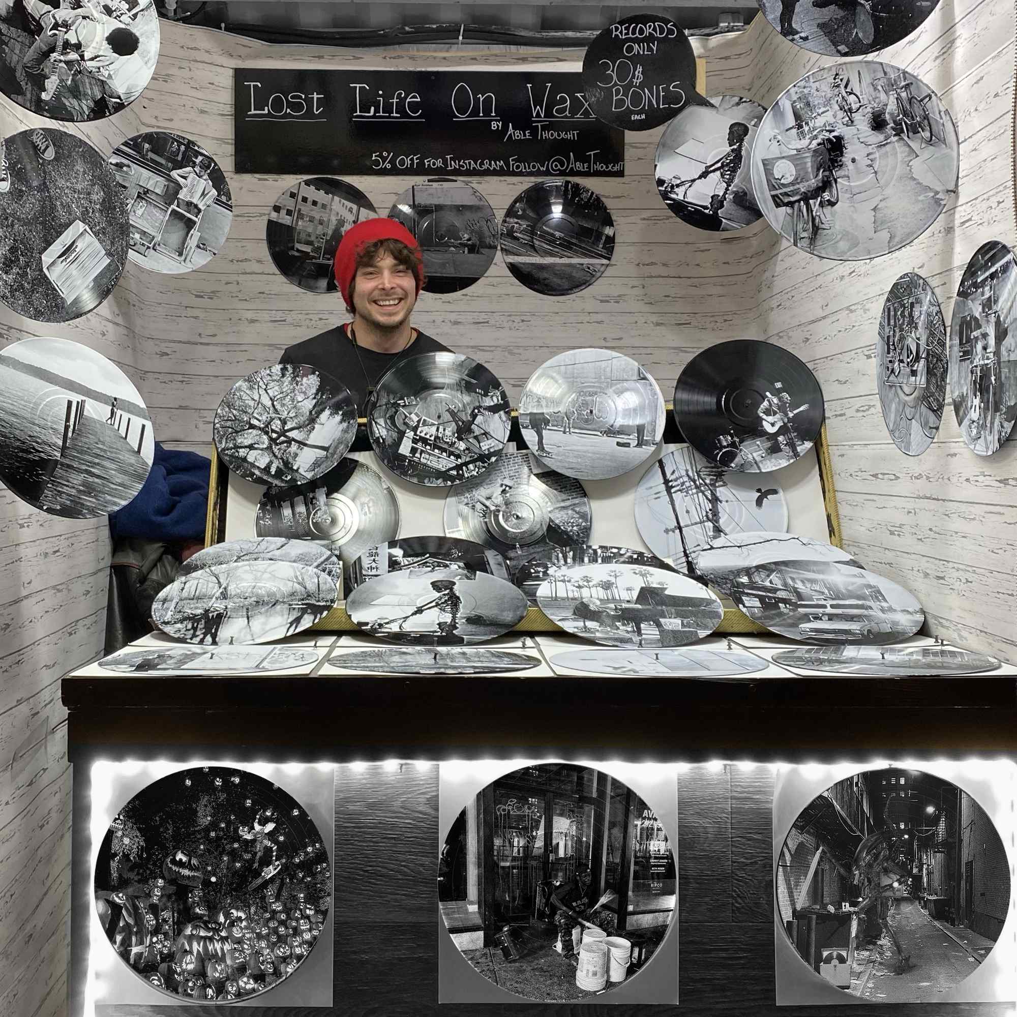 Vinyl record photo art of a street drummer performing under city lights, displayed at an art market booth.