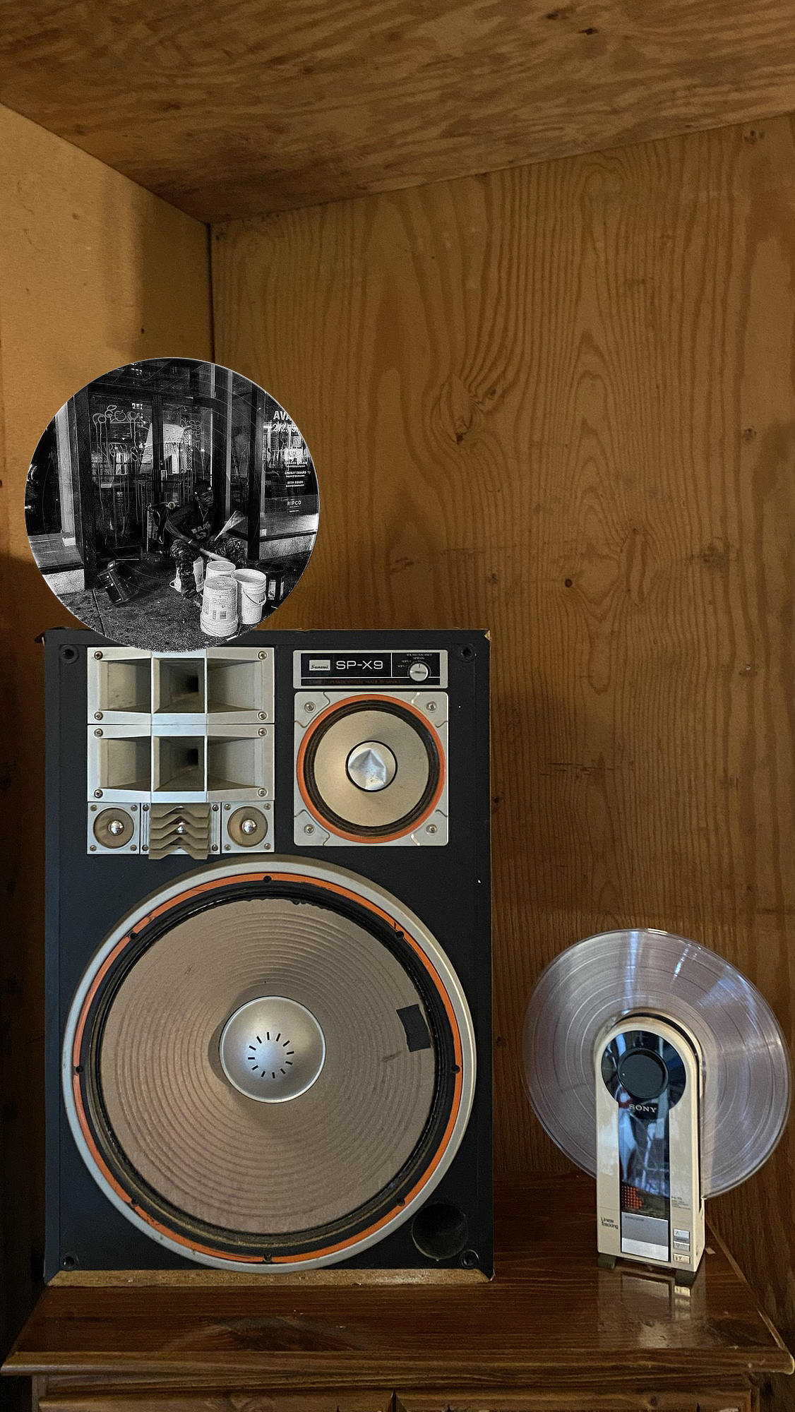 Circular vinyl record wall art of a bucket drummer performing on a graffiti-covered street in NYC, displayed in a music room.