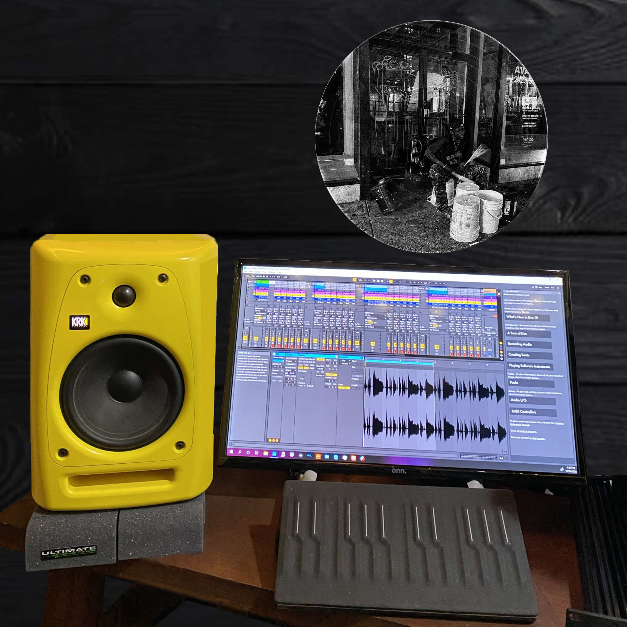 Black and white vinyl record wall art of a bucket drummer performing on a New York City sidewalk at night, displayed as office decor.