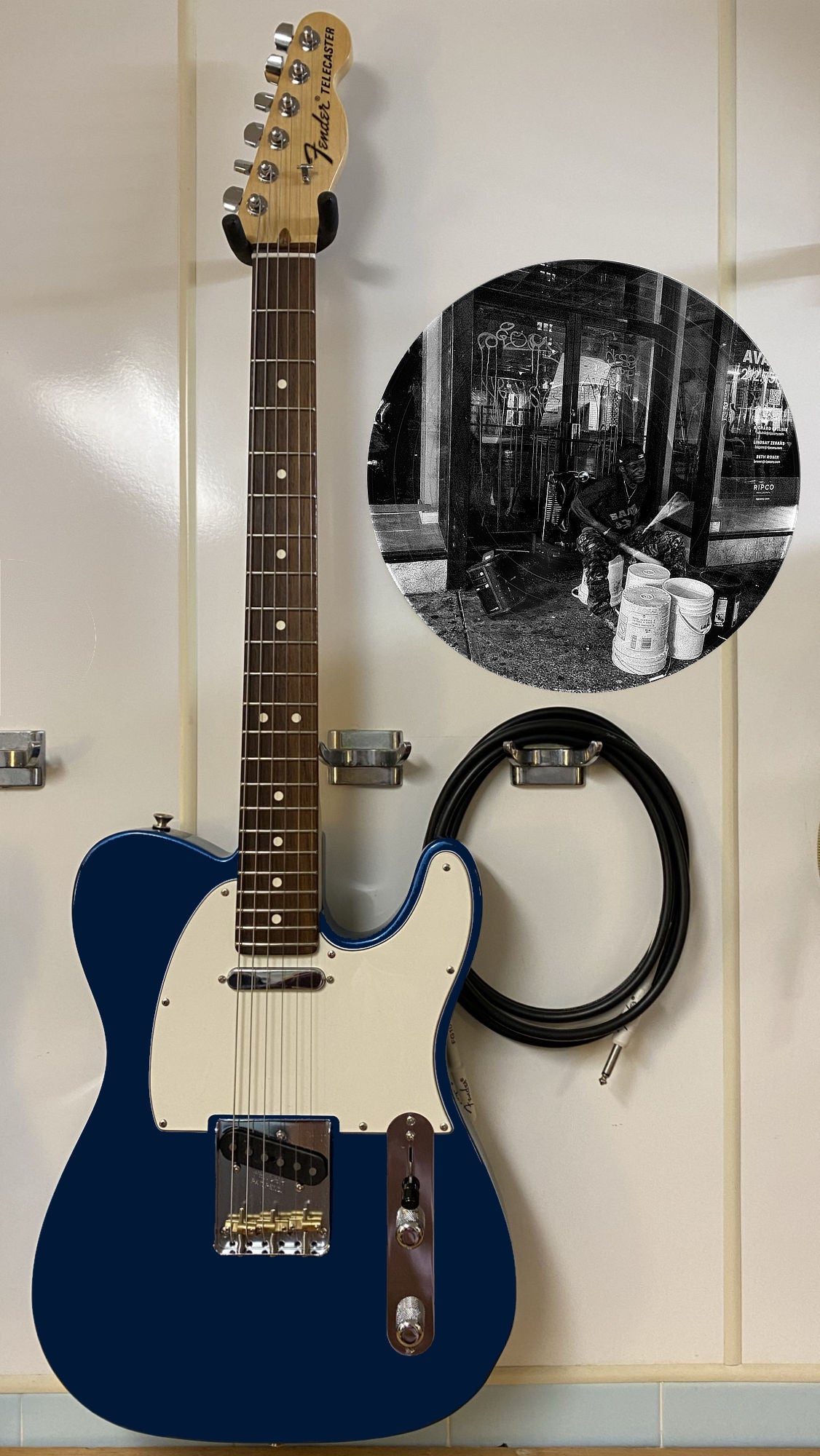 Black and white vinyl record photo art of a bucket drummer playing in New York City, featured in a recording studio setting.