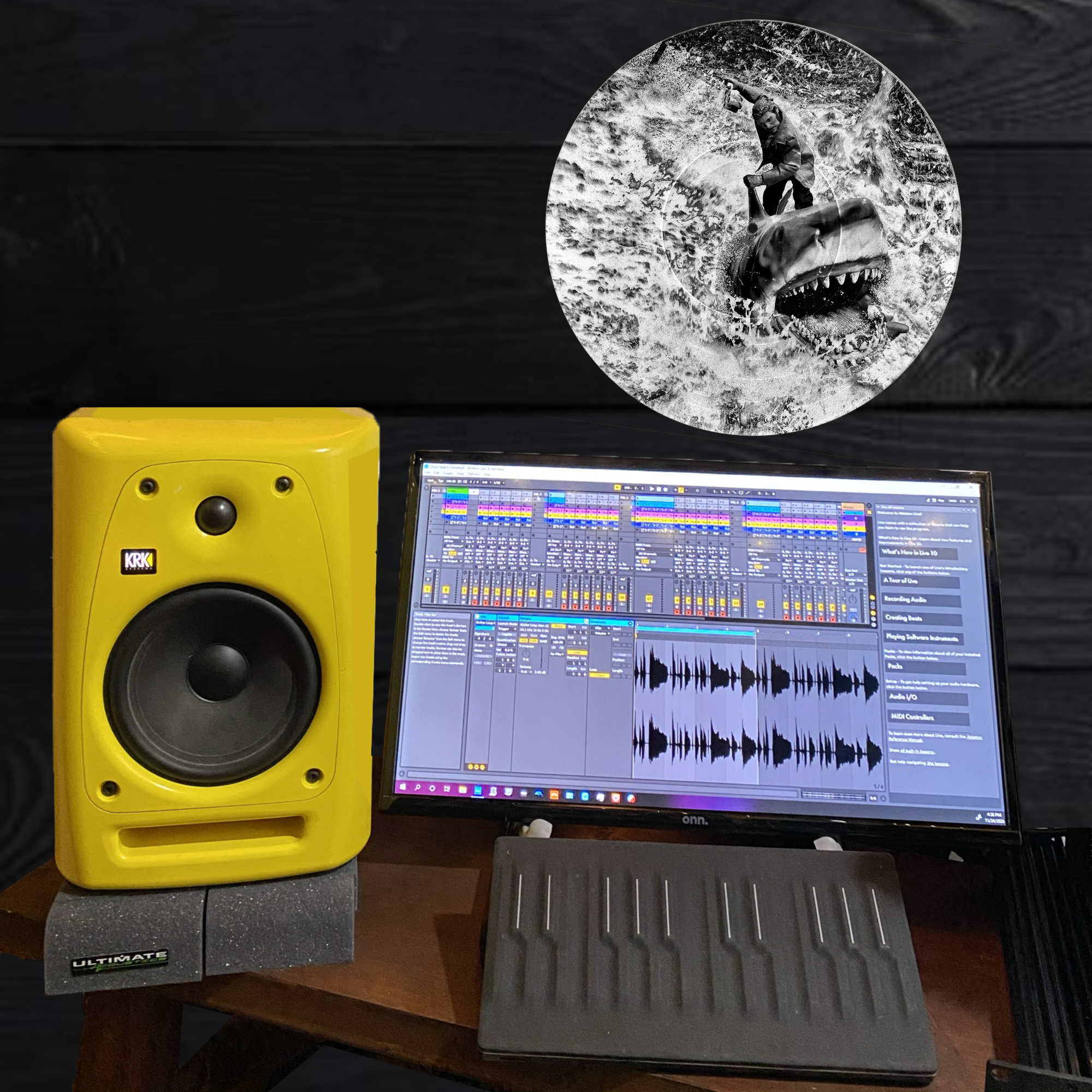 Black and white vinyl record wall art of Quint from Jaws riding Bruce the shark with a six-pack of beer, displayed as office decor.