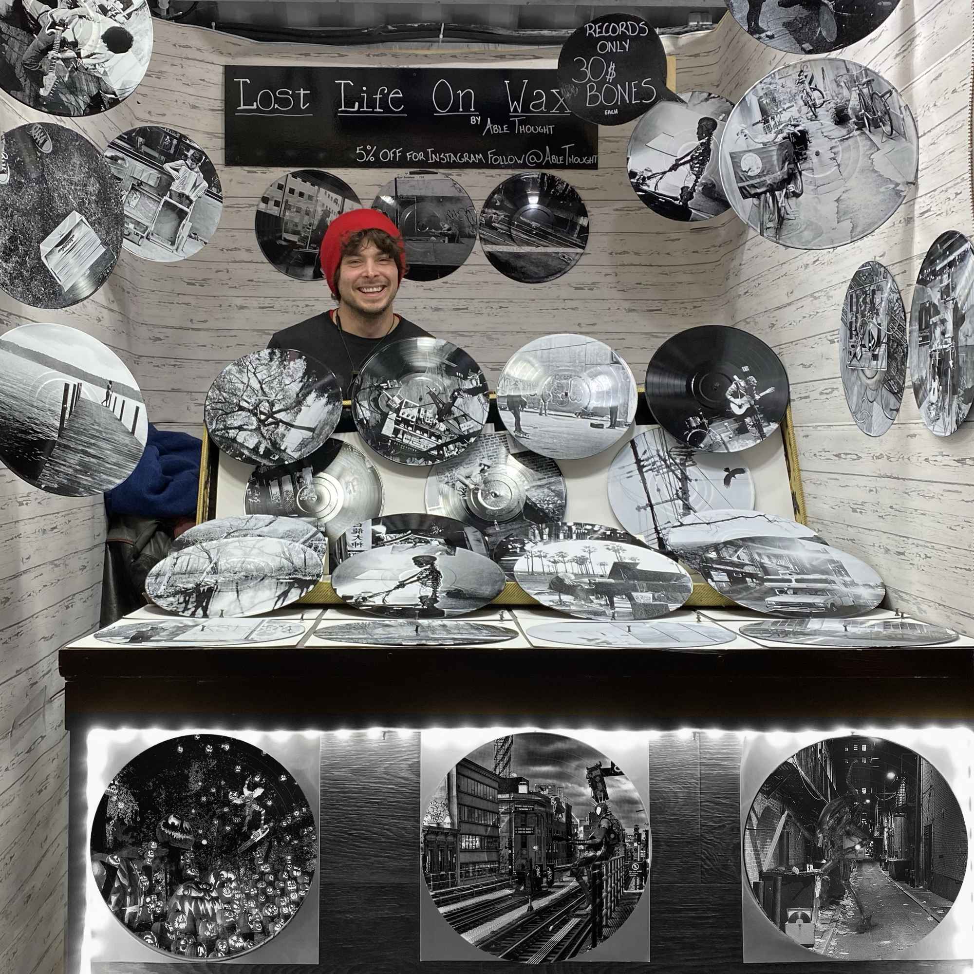 Vinyl record photo art of Spider-Punk playing guitar at a Brooklyn train station, displayed at an art market booth.