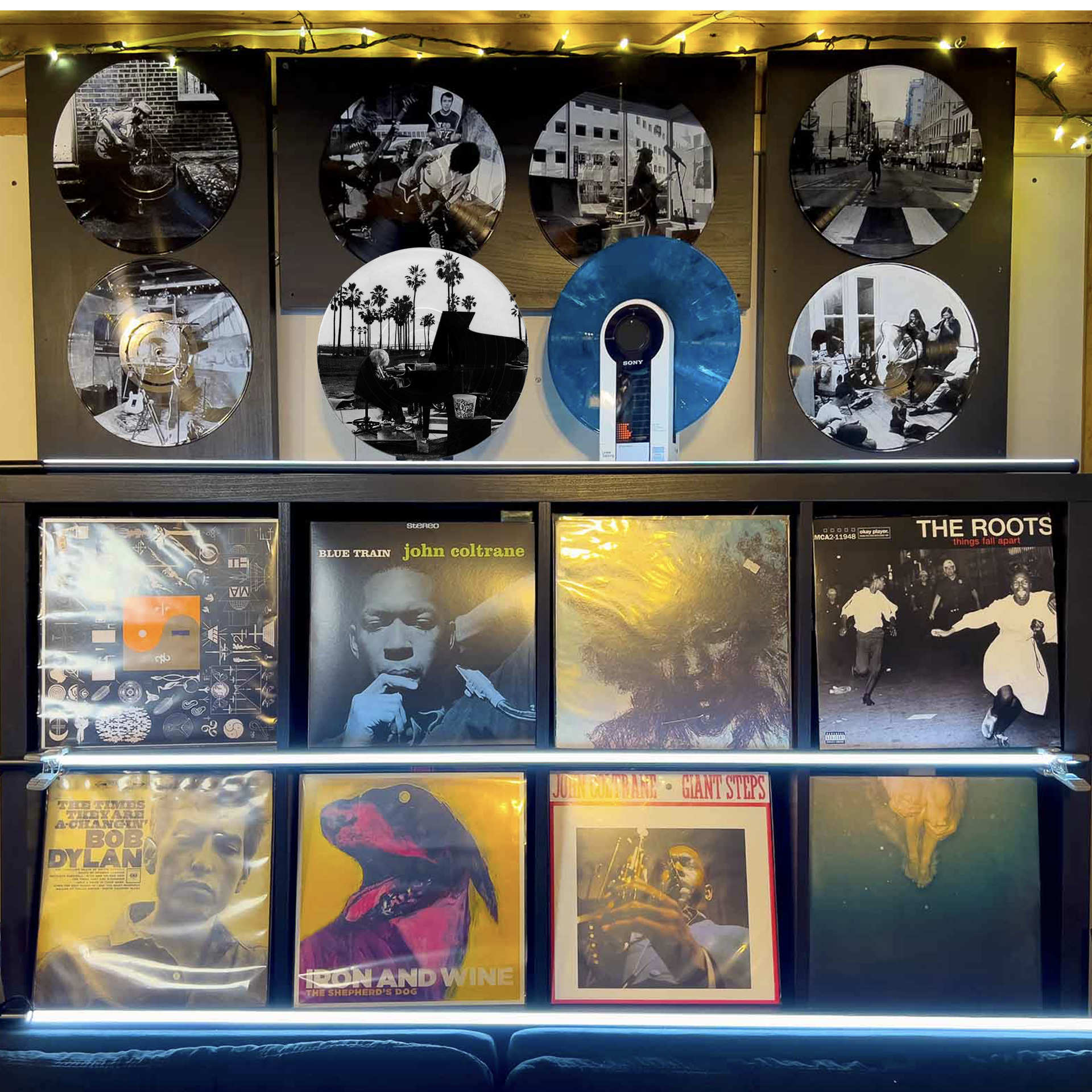 Vinyl record photo art of a piano player on Venice Beach at sunset, arranged on a gallery wall.