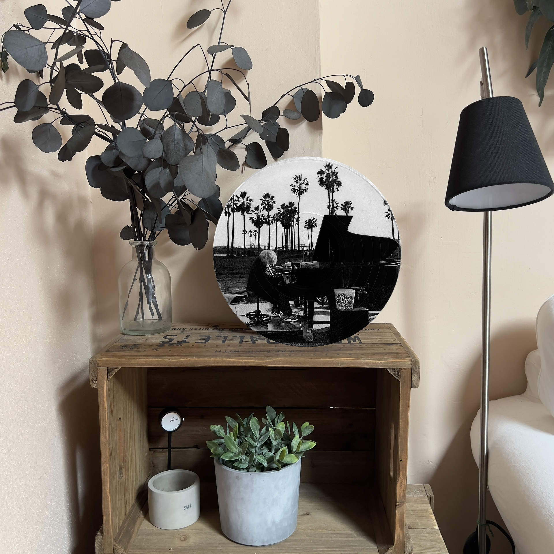Upcycled vinyl record photo art of a pianist at sunset with palm trees, styled as living room wall decor.