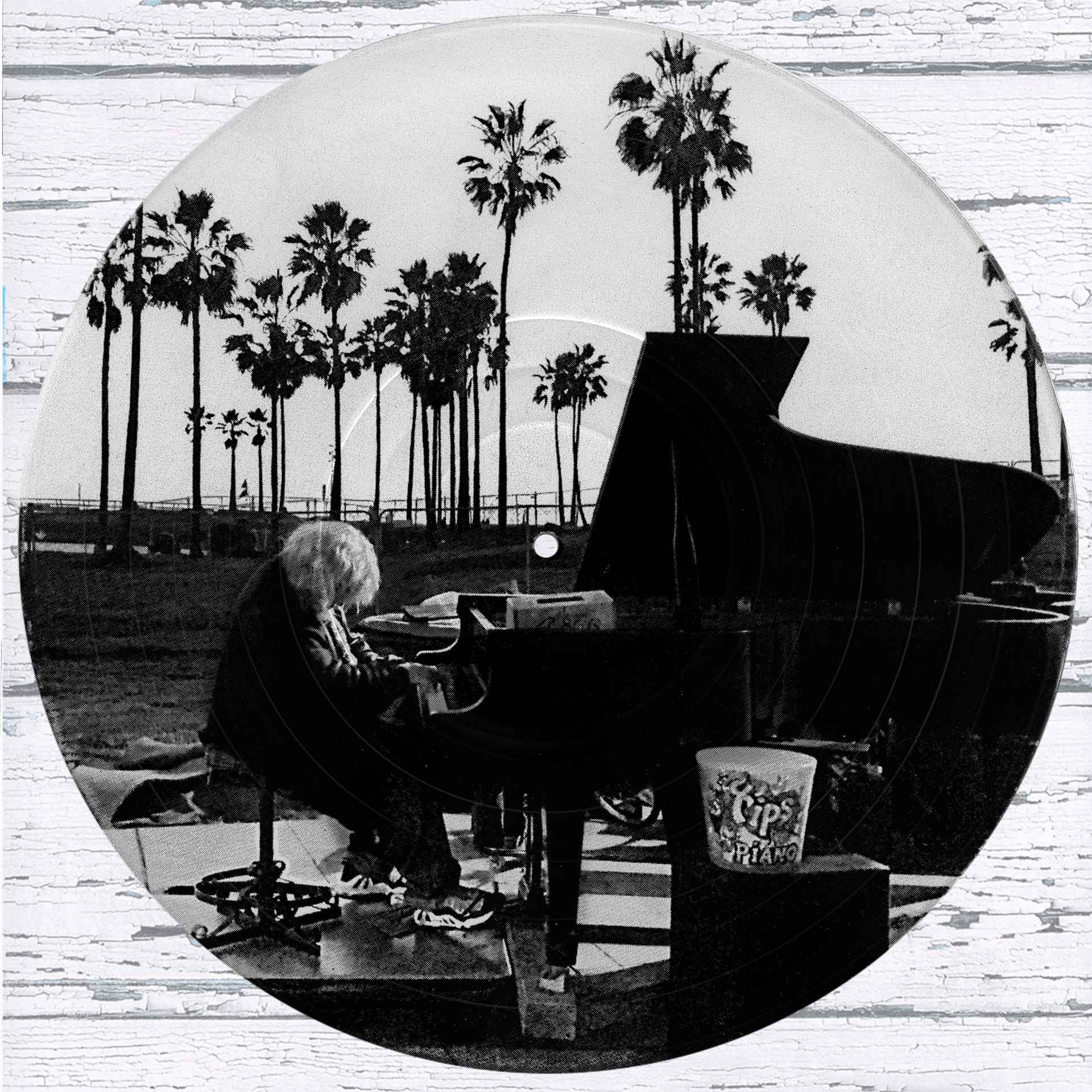 Venice Beach Piano Player vinyl record photo art featuring a black and white photograph of a pianist at sunset with palm trees in the background.