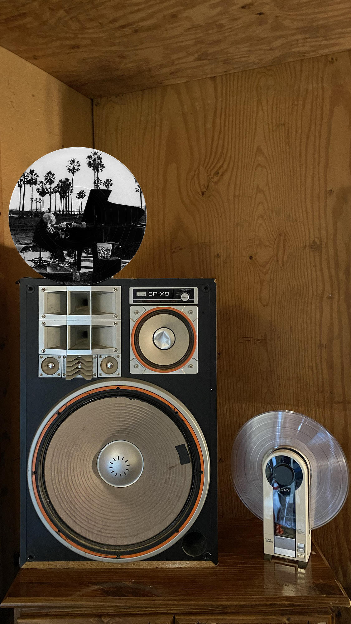 Circular vinyl record wall art of a pianist at sunset on Venice Beach, displayed in a music room.