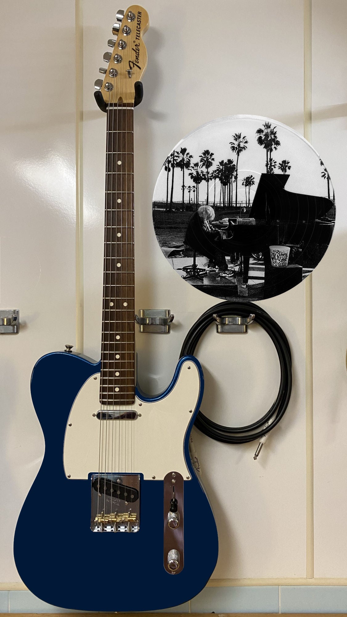 Black and white vinyl record photo art of a piano player at Venice Beach sunset, featured in a recording studio setting.